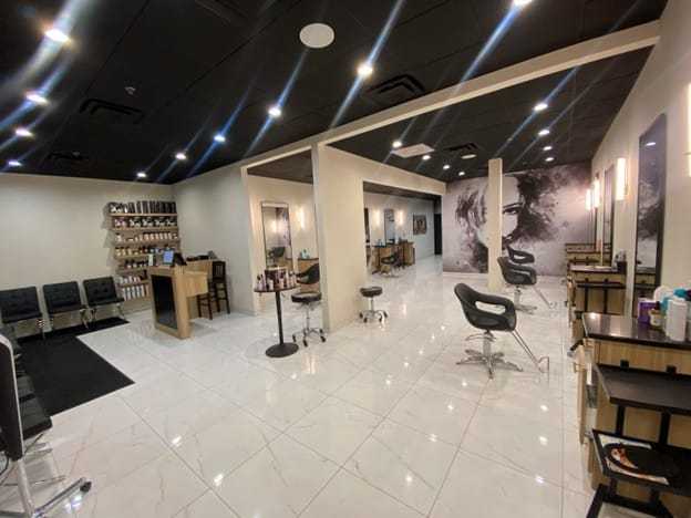 Salon interior with modern chairs, hair products, and sleek decor.